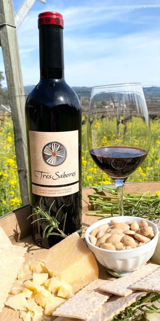 Tres Sabores North Coast Cabernet Franc bottle and glass with snacks beside them