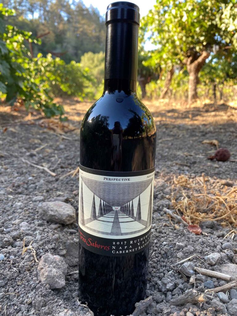 bottle of Tres Sabores Rutherford Cabernet in the vineyard
